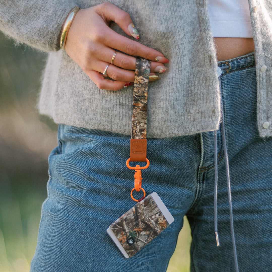 female showing off sustainable wallet bundled with lanyard strap for easy carry