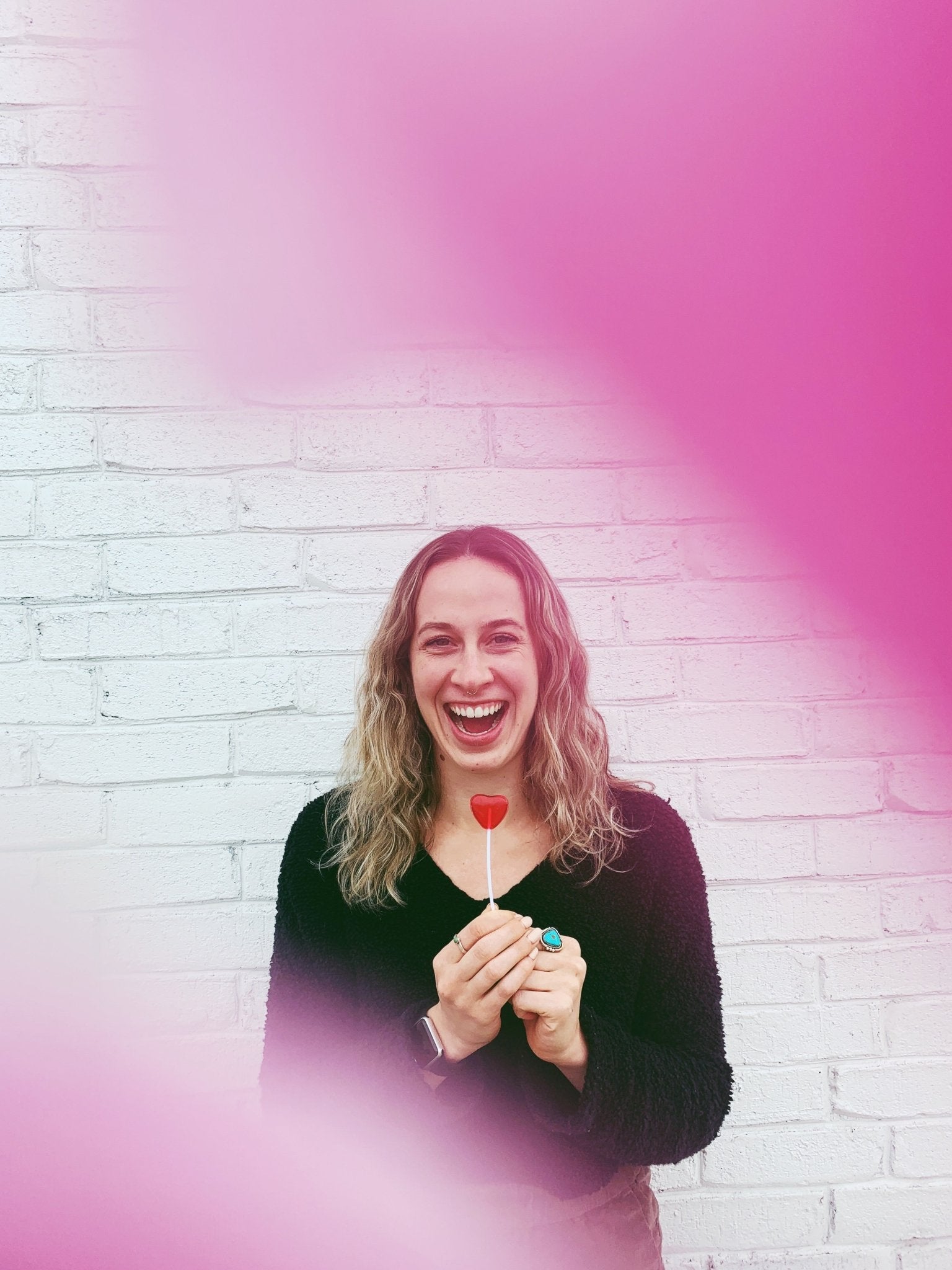 Girl smiling while holding a sucker
