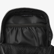 Inside of the Thread® Black crossbody bag showing pockets and printed lining