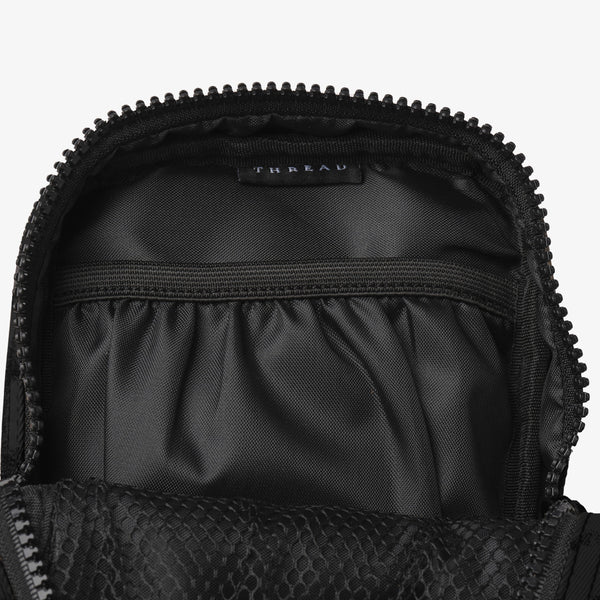 Inside of the Thread® Black crossbody bag showing pockets and printed lining