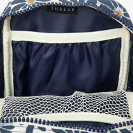 Inside of the Thread® Emmeline Navy crossbody bag showing pockets and printed lining