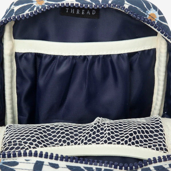 Inside of the Thread® Emmeline Navy crossbody bag showing pockets and printed lining