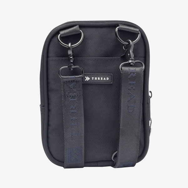 Inside of the Thread® Black crossbody bag showing pockets and printed lining