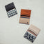 White leather wallet with navy and white floal elastic
