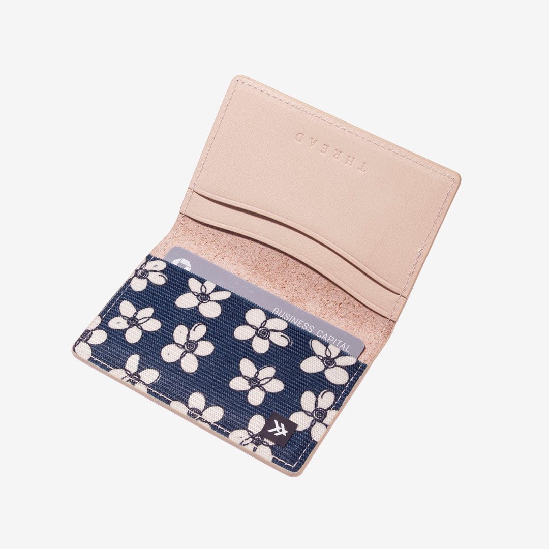 White leather wallet with navy and white floal elastic
