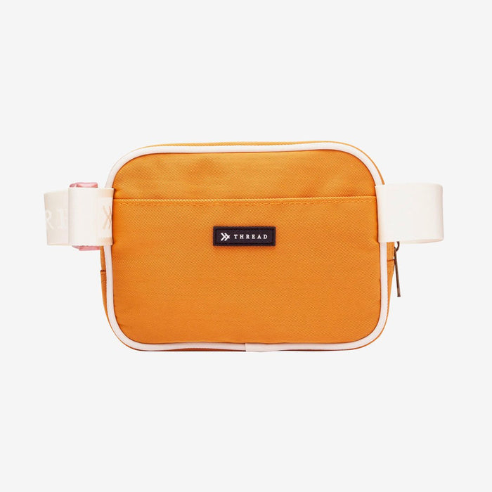 Orange fanny pack with white trims and floral interior