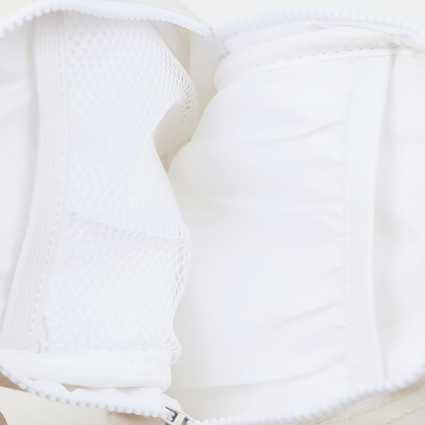 Inside of the Thread® Off White crossbody bag showing pockets and printed lining