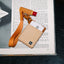 Brown leather card holder with orange and cream striped elastic