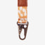 Orange and cream leopard print keychain clip with brown leather