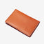 Brown leather bifold wallet with orange and white leopard print elastic
