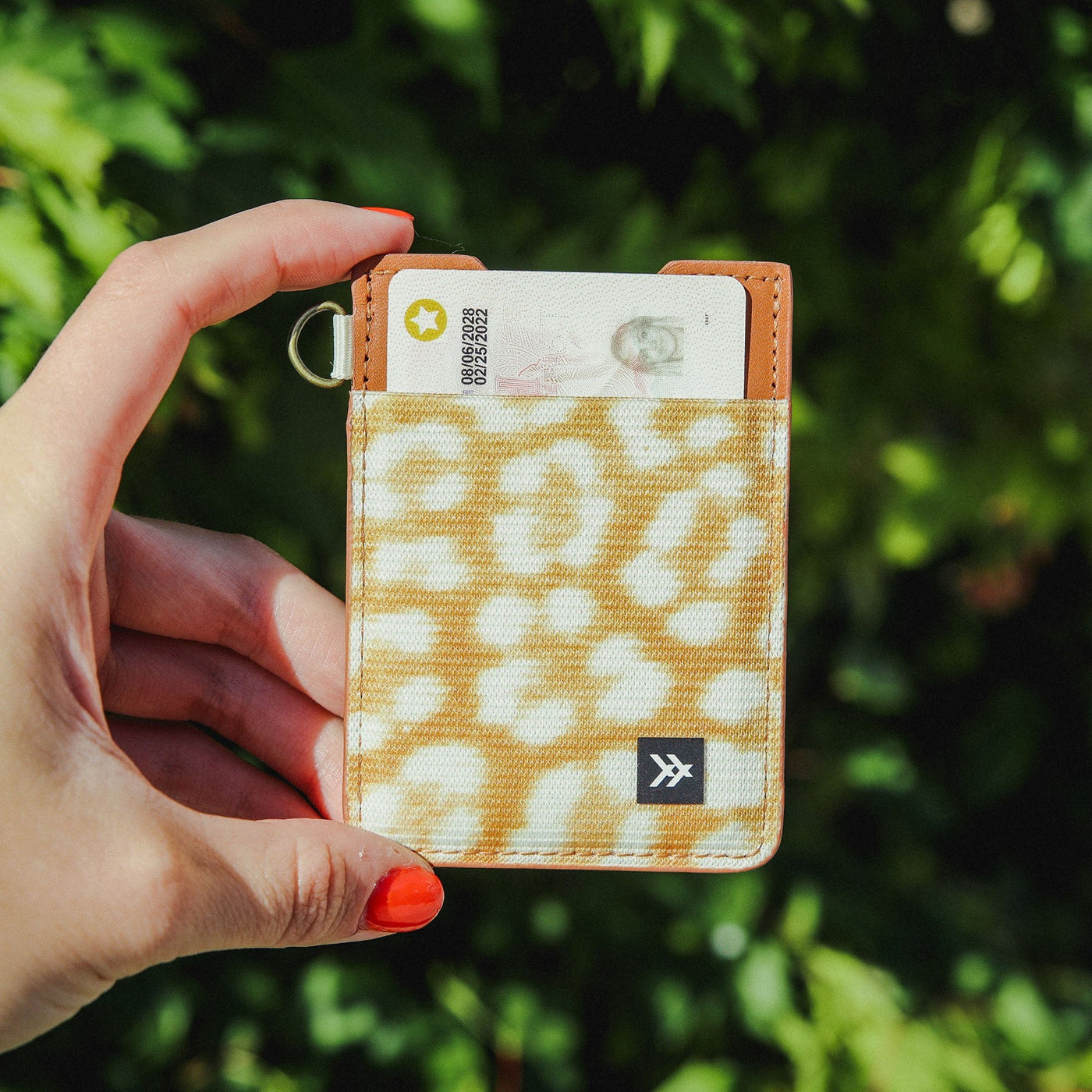 Brown leather card holder with orange and cream leopard print elastic