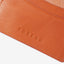 Brown leather bifold wallet with orange and white leopard print elastic