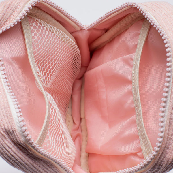 Inside of the Thread® Rose Dust Corduroy crossbody bag showing pockets and printed lining