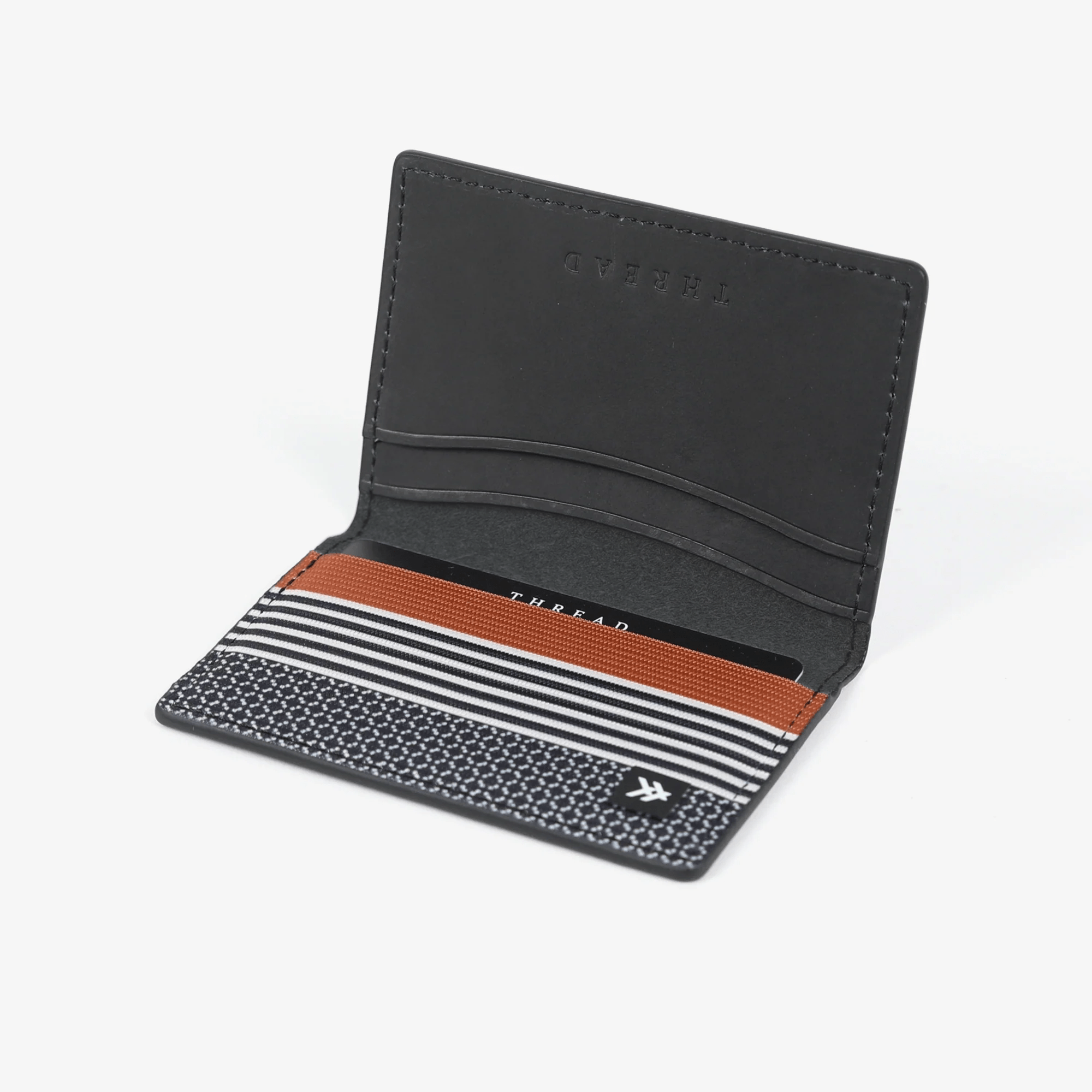 Black, white, and brown striped bifold wallet